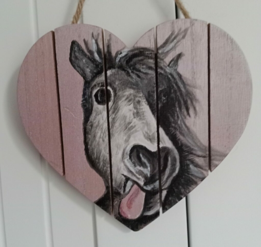 Painting of a horse on a wooden heart